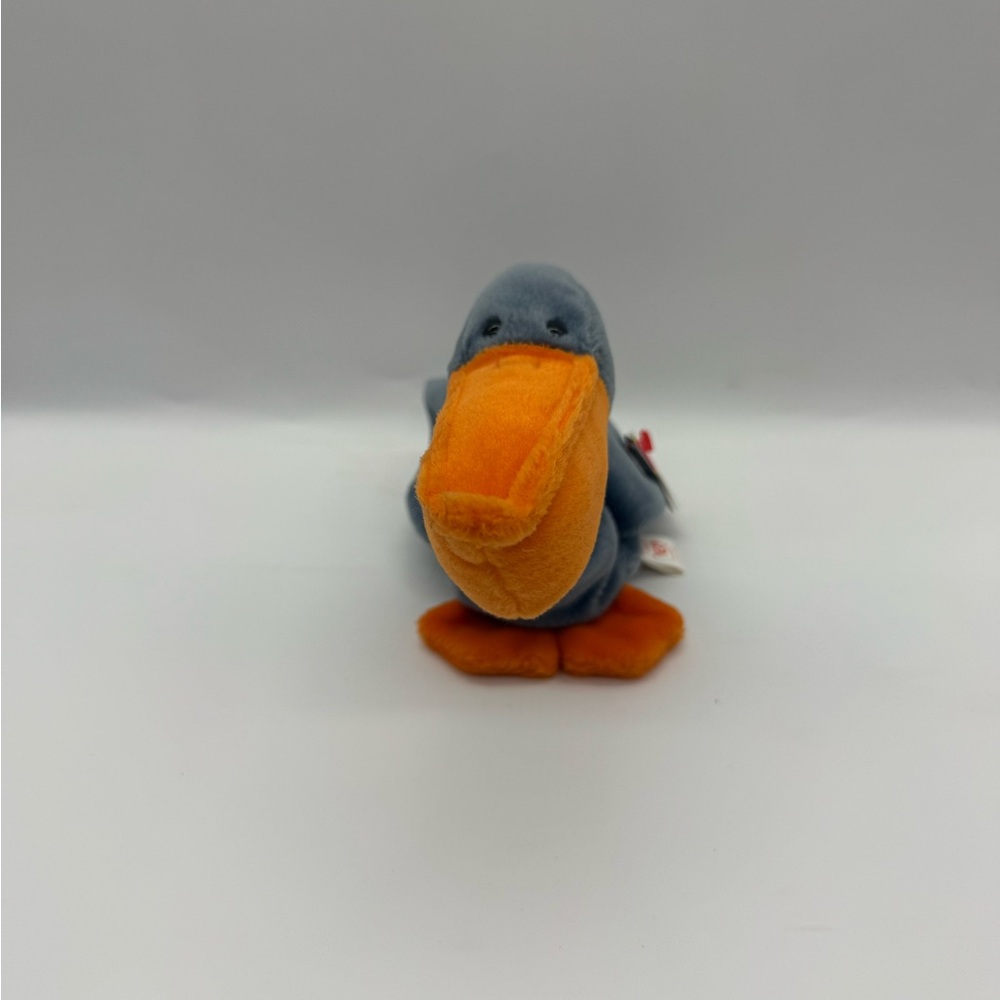 This collectible item is a "Scoop" the Pelican plush toy manufactured by Ty Inc.